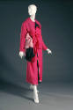 Long sleeve coat dress with hot pink, pink and black layers and large tied bows closure
