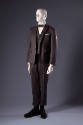Grey wool suit with long sleeve jacket with patch, vest, and short cuffed pants and bow tie
