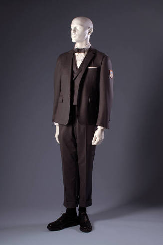 Grey wool suit with long sleeve jacket with patch, vest, and short cuffed pants and bow tie