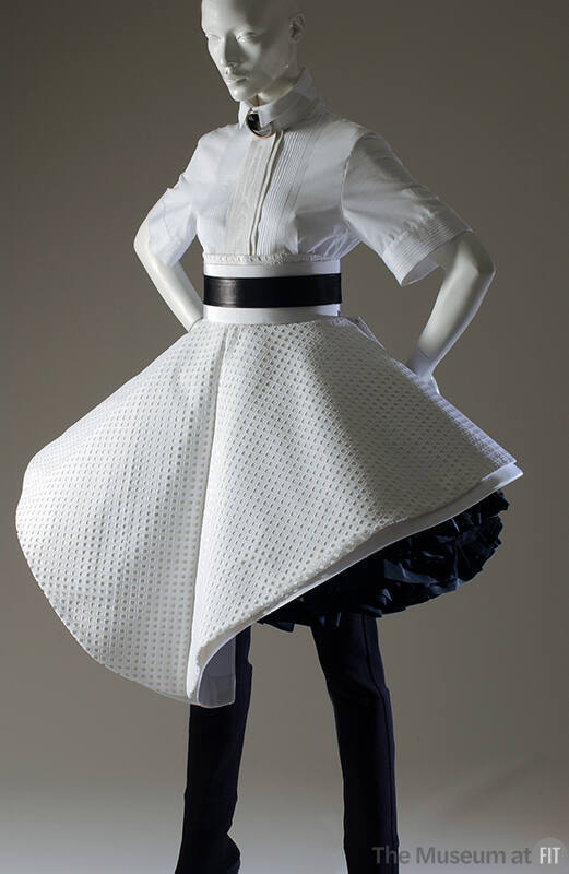 White cotton short sleeve shirt with white eyelet asymmetic circle skirt over black ruffled sli…