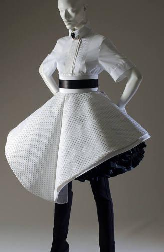 White cotton short sleeve shirt with white eyelet asymmetic circle skirt over black ruffled sli…