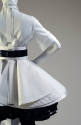 Back detail view of white short sleeve shirt, wide leather belt over layered white eyelet skirt…