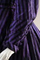 Detail of purple and black striped dress sleeve with button cuffs