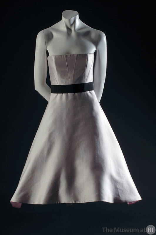 Pale pink strapless dress with full bell to-the-knee skirt and black ribbon belt