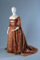 Floor length brown silk dress with blue flowers in grid pattern and off-white neckerchief