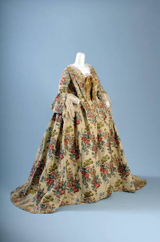 Floral pattern brocaded silk floor length gown with 3/4 sleeves with lace trim, gold bow at low…