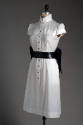 White cap sleeve to-the-knee button front dress with wide black leather belt