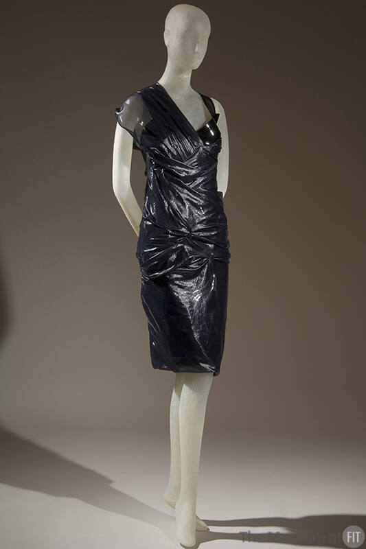 Black patent leather textured knee length dress with one sheer cap sleeve and one shoulder stra…