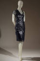 Black patent leather textured knee length dress with one sheer cap sleeve and one shoulder stra…