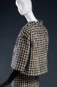Detail back view of black and off-white wool houndstooth check jacket with 3/4 sleeves, matchin…