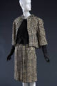 Close up view of black and off-white wool houndstooth check jacket with 3/4 sleeves, matching s…