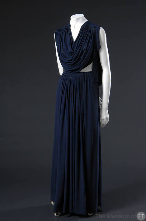 Sleeveless floor length blue silk dress with draped bodice, bare midriff and gathered skirt