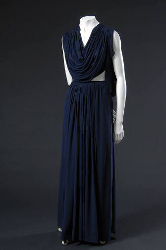 Sleeveless floor length blue silk dress with draped bodice, bare midriff and gathered skirt