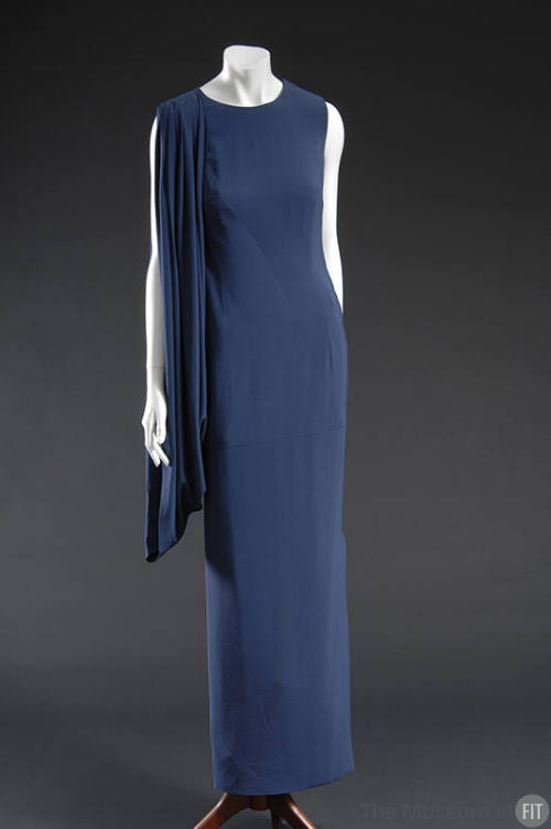Blue floor length sleeveless dress with draped gathered shoulder swag 
