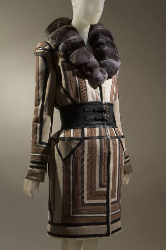 Coat in geometric stripes of brown, tan, off-white and black with wide black double buckle clos…