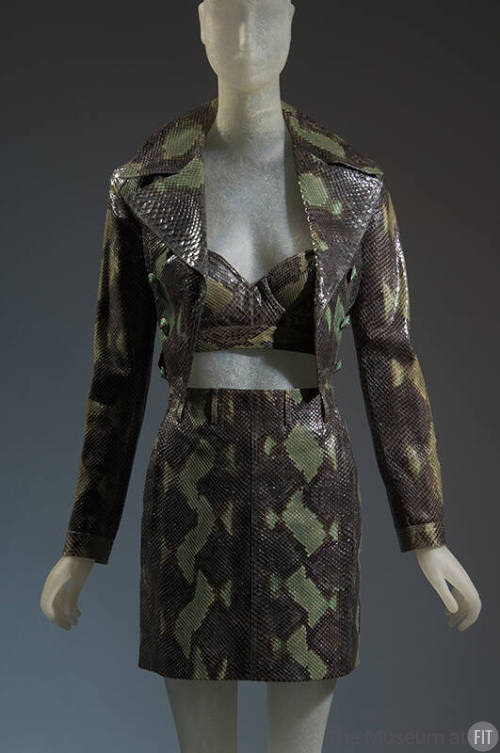 Green snakeskin ensemble of cropped jacket with wide notched lapels, matching bra and miniskirt