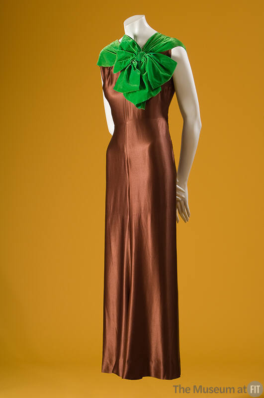 Brown silk sleeveless below ankle evening gown with bright green velvet neckline and oversize b…