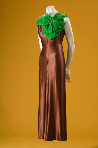 Brown silk sleeveless below ankle evening gown with bright green velvet neckline and oversize b…