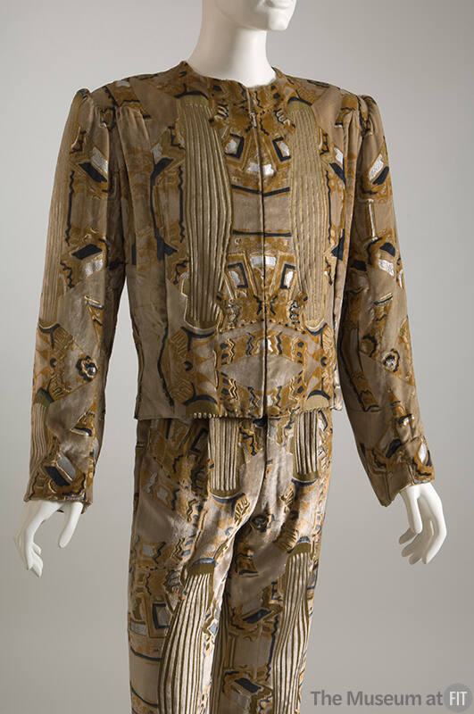 Man’s beige velvet suit stenciled with gold, silver and blue art deco pattern of fitted collarl…