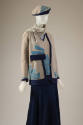 ¾ view of grey knit ensemble with turquoise and navy blue Art Deco wedge motifs 