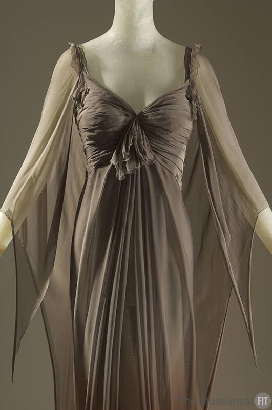 Brown silk chiffon evening gown with pleated bodice tied in center self ruffle and fly away pan…