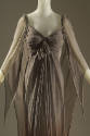 Brown silk chiffon evening gown with pleated bodice tied in center self ruffle and fly away pan…