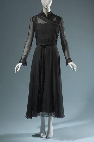 Black evening ensemble of sheer long sleeve cross over top and floor length skirt with braided …