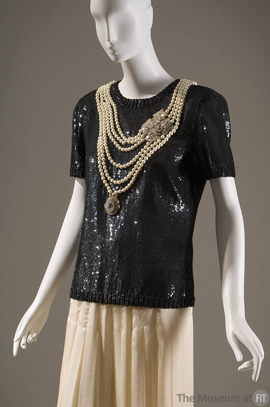Evening set of black short sleeve sequined top with multi-strand pearl necklace with two jewel …