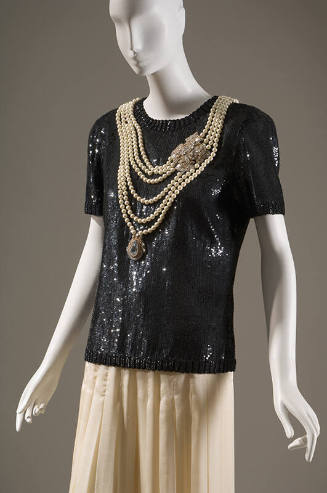 Evening set of black short sleeve sequined top with multi-strand pearl necklace with two jewel …
