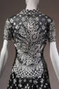 Back view of black and white floral evening dress bodice showing large scale white floral print…