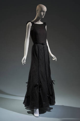 Black sleeveless floor length dress with horizontal tucks across bodice and chevron tucks down …