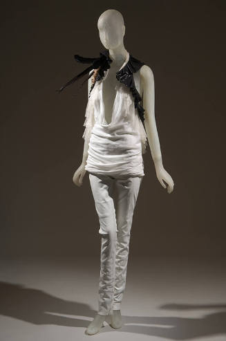 Ensemble of white halter top with plunging neckline trimmed with white and black ruffles, black…