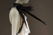 Detail view of white ensemble showing side view of halter top trimmed with pink, white and blac…