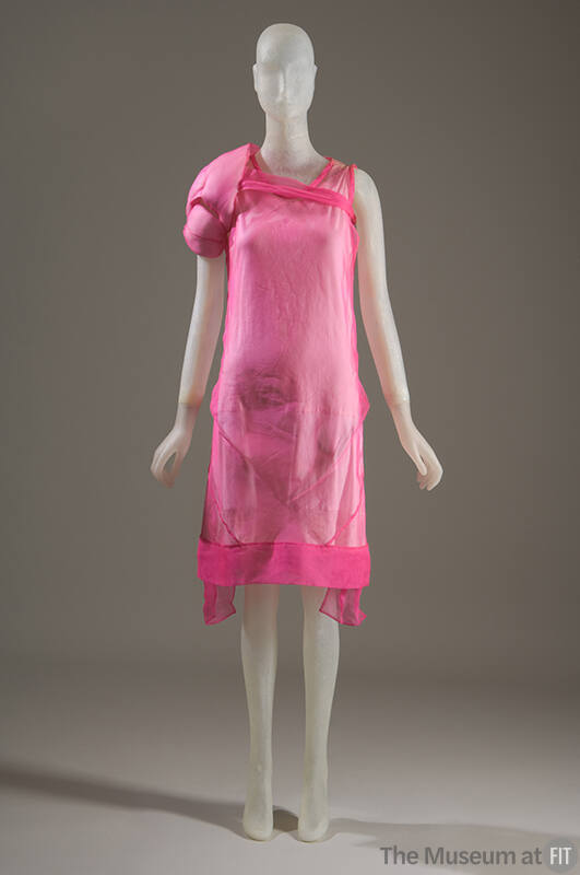 Sheer hot pink knee length dress with single left puffed sleeve tied across bodice and side pan…