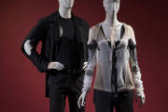 Man’s black motorcycle style jacket, tank top and pants on left with women’s sheer beige, black…
