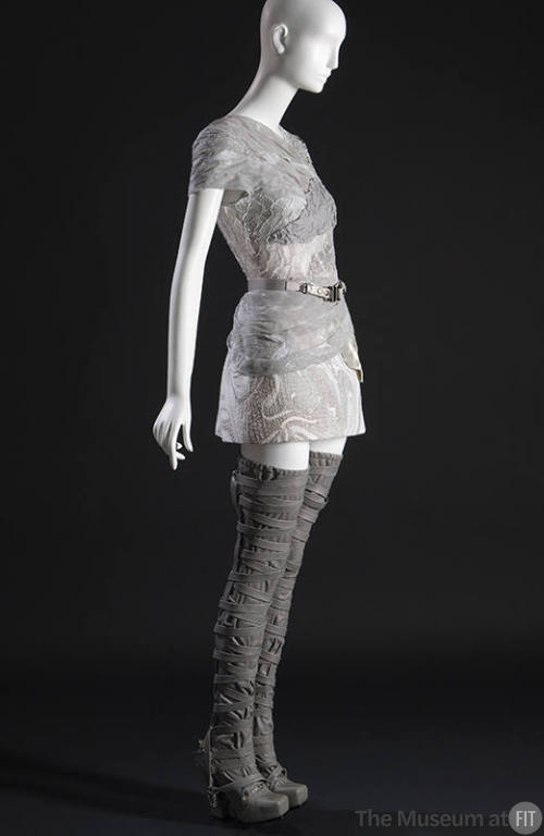 ¾ view of grey and white mini dress of piecework marbled leather and cotton tulle with single l…