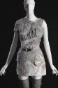 Detail view of grey and white mini dress showing piecework marbled leather and cotton tulle, si…