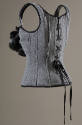 Back view of grey wool corset with shouder straps and lace-up back