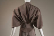 Back view of taupe dress bodice with short sleeves and belt 