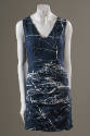 Sleeveless blue satin v-neck mini dress with allover white splatter print and pleated skirt