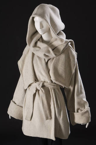 Off-white hooded  hip length wool coat with hanging front flaps, wide cuffed sleeves, sash belt