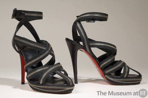 Black high heel sandals with multiple criss-cross zipper straps and ankle buckle straps 