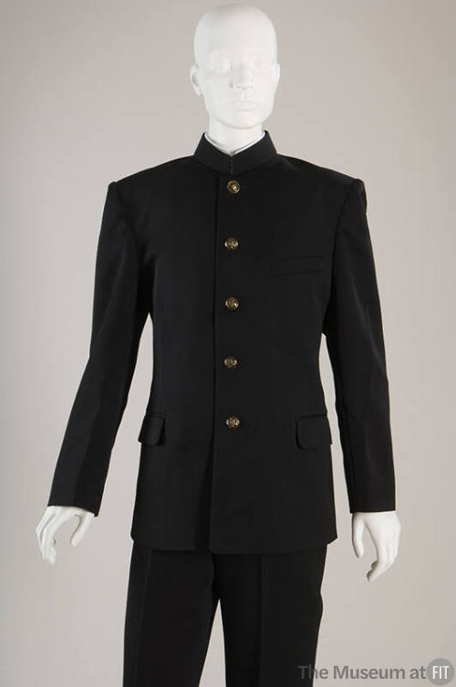 Black jacket with band collar, flap pockets, brass buttons and black pants