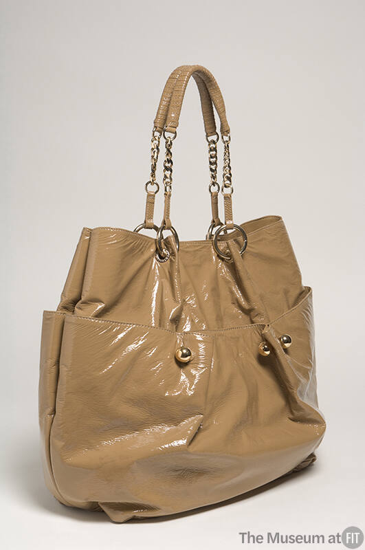 Large tan faux shiny leather tote bag with side pockets and chain and braided handles