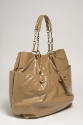 Large tan faux shiny leather tote bag with side pockets and chain and braided handles