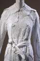 Detail of white embroidered cotton handkerchief double-breasted coat with belt 