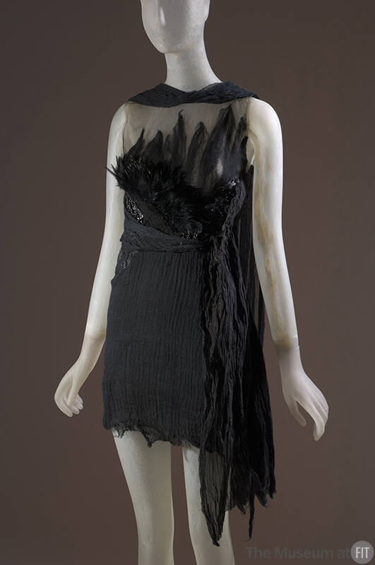 Black sleeveless mini dress with sheer bodice with feathers, crinckled skirt with long side pan…