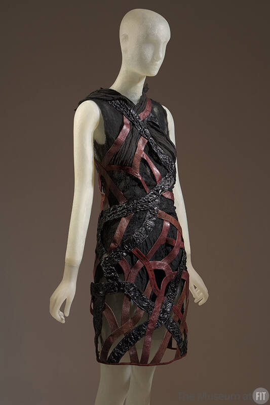Sleeveless above-the-knee sheer dress with black reptile pattern and red leather intertwined al…