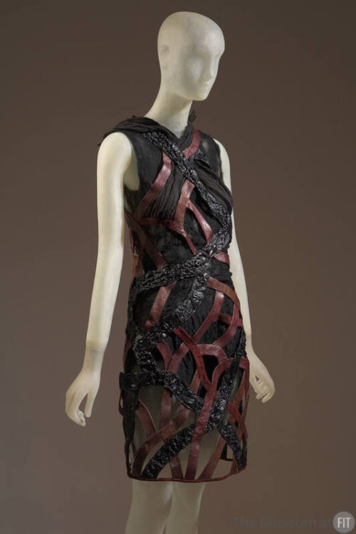 Sleeveless above-the-knee sheer dress with black reptile pattern and red leather intertwined al…