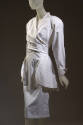 White cotton long sleeve jacket with lapels, wrap waist and peplum and matching slim skirt